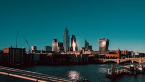 city skyline across body of water during night time