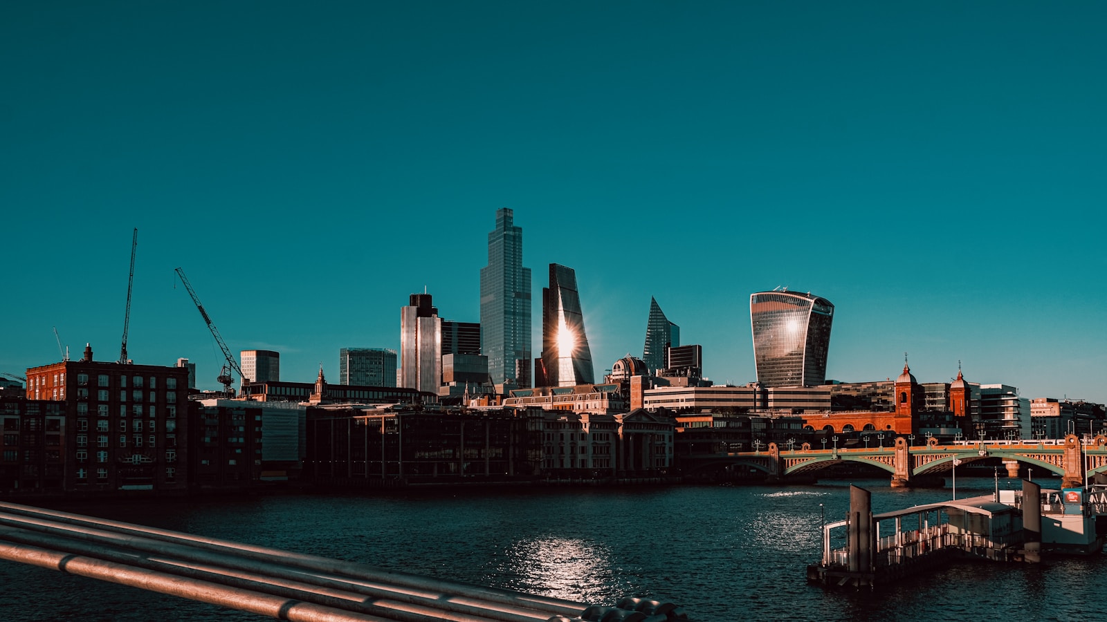 city skyline across body of water during night time